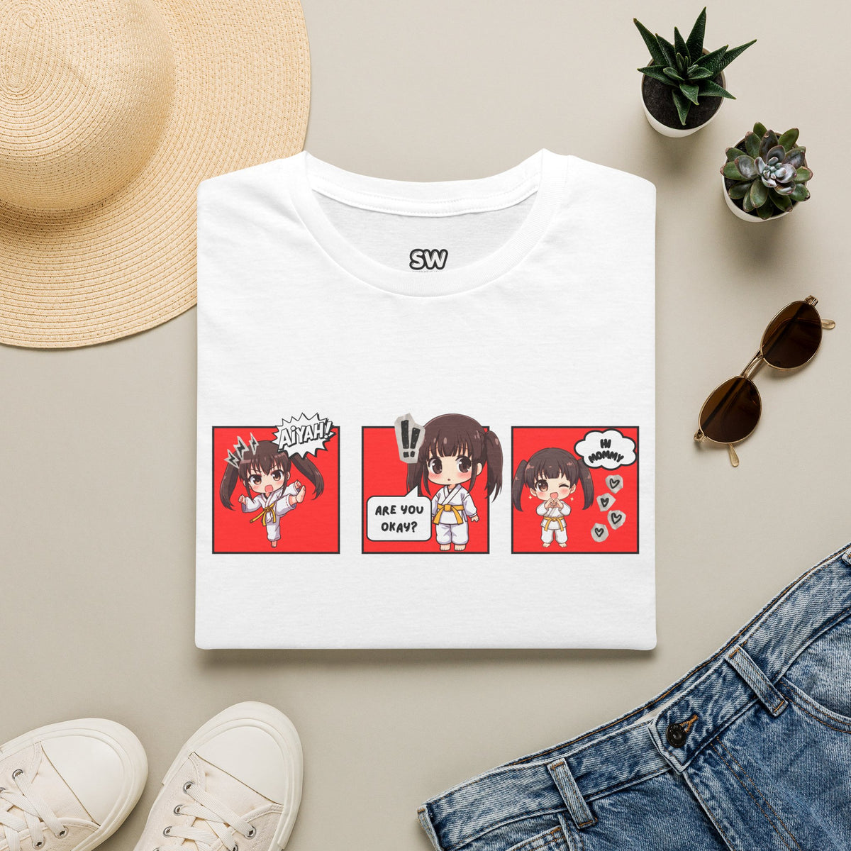 Are You Okay? unisex softstyle t-shirt in white with chibi taekwondo girl three-panel comic strip graphic — "Aiyah!", "Are You Okay?", "Hi Mommy"