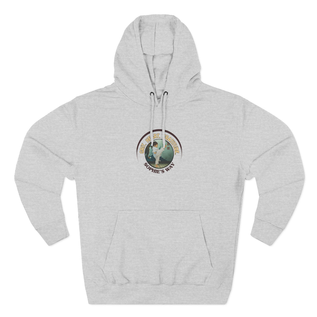 A heather grey pullover hoodie with a circular graphic on the chest that reads 'Grit. Heart. Gratitude. Sophie's Way' around a globe design around a taekwondo tot doing a side kick. The hoodie features a drawstring hood, long sleeves, and a front kangaroo pocket.