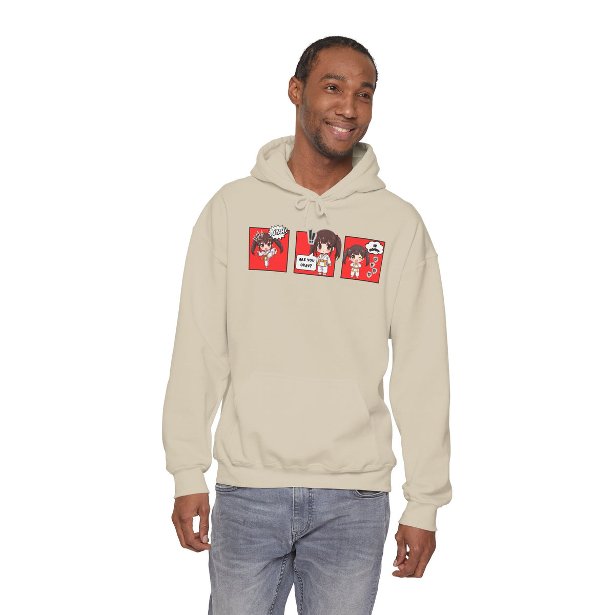 A sand color pullover hoodie with a red and multicolor anime-style graphic print on the chest of a taekwondo girl saying 'Aiyah!' then 'Are you okay?', and then 'Hi Mommy."