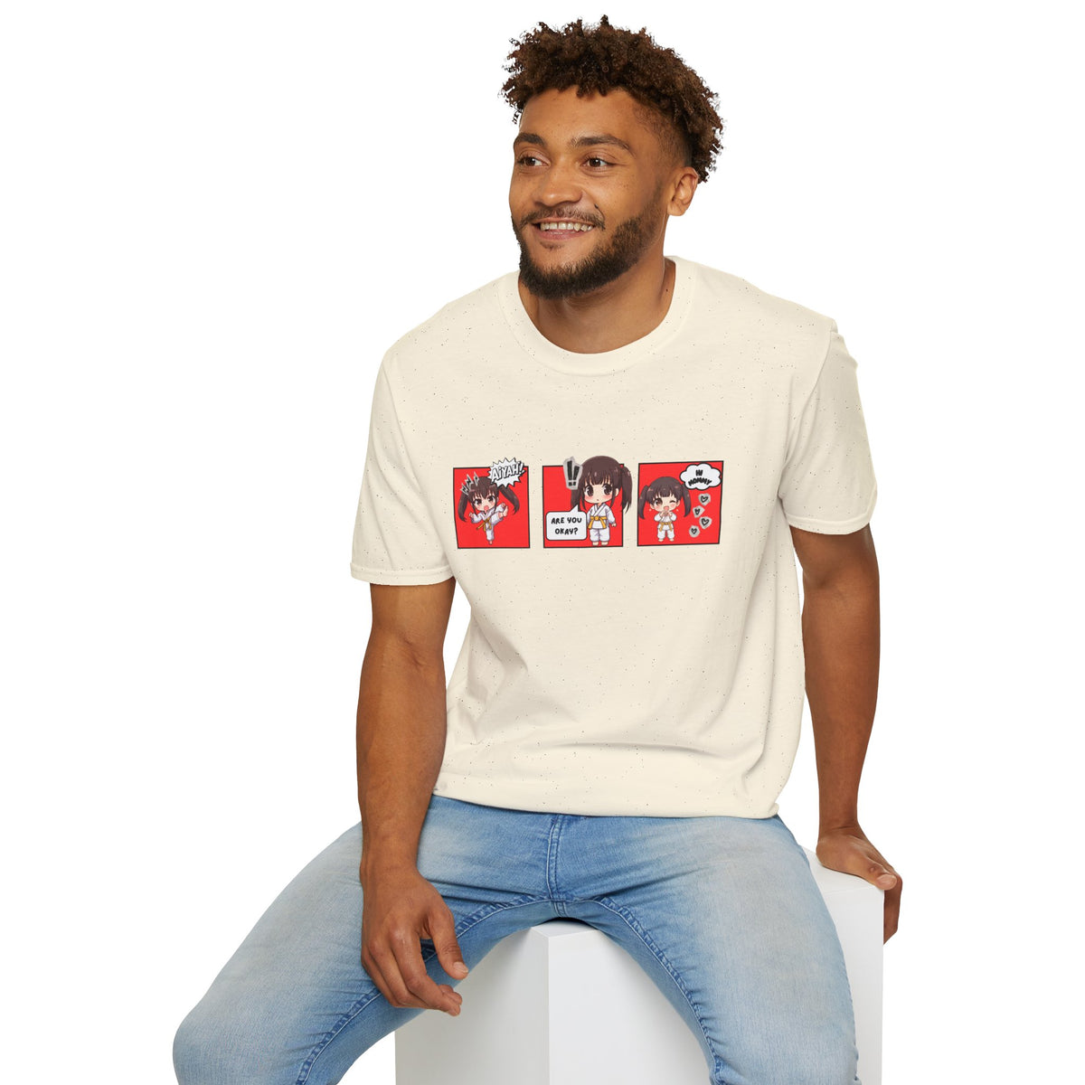Are You Okay? unisex softstyle t-shirt in natural/cream with chibi taekwondo girl three-panel comic strip graphic — "Aiyah!", "Are You Okay?", "Hi Mommy"