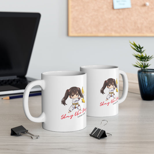 Two mugs with the same image of a taekwondo girl slicing a banana with a sword with text that reads Slay the Day and Sophie's Way.