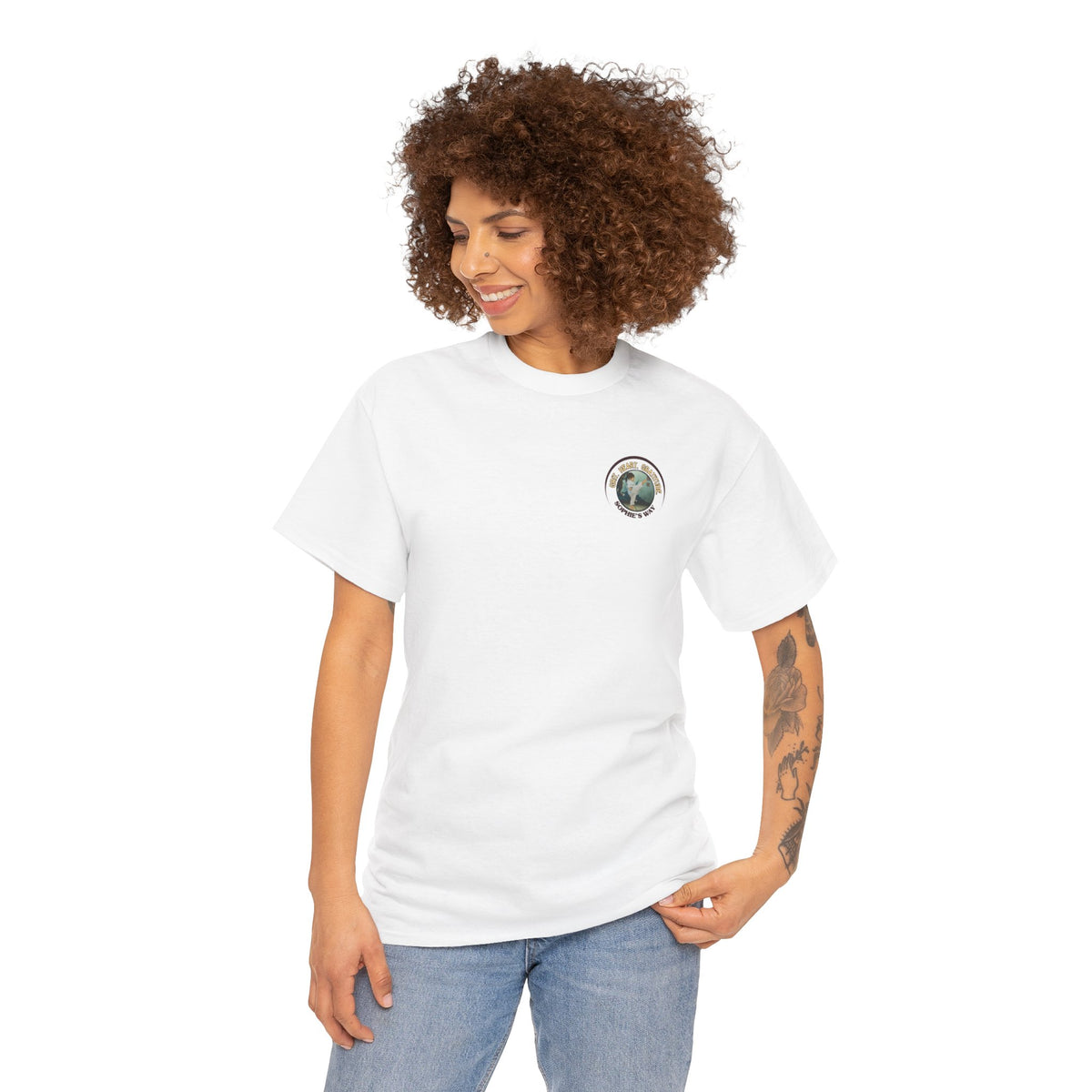 White t-shirt with a small round logo of a taekwondo girl doing a side kick and the words Grit. Heart. Gratitude. Sophie's Way.