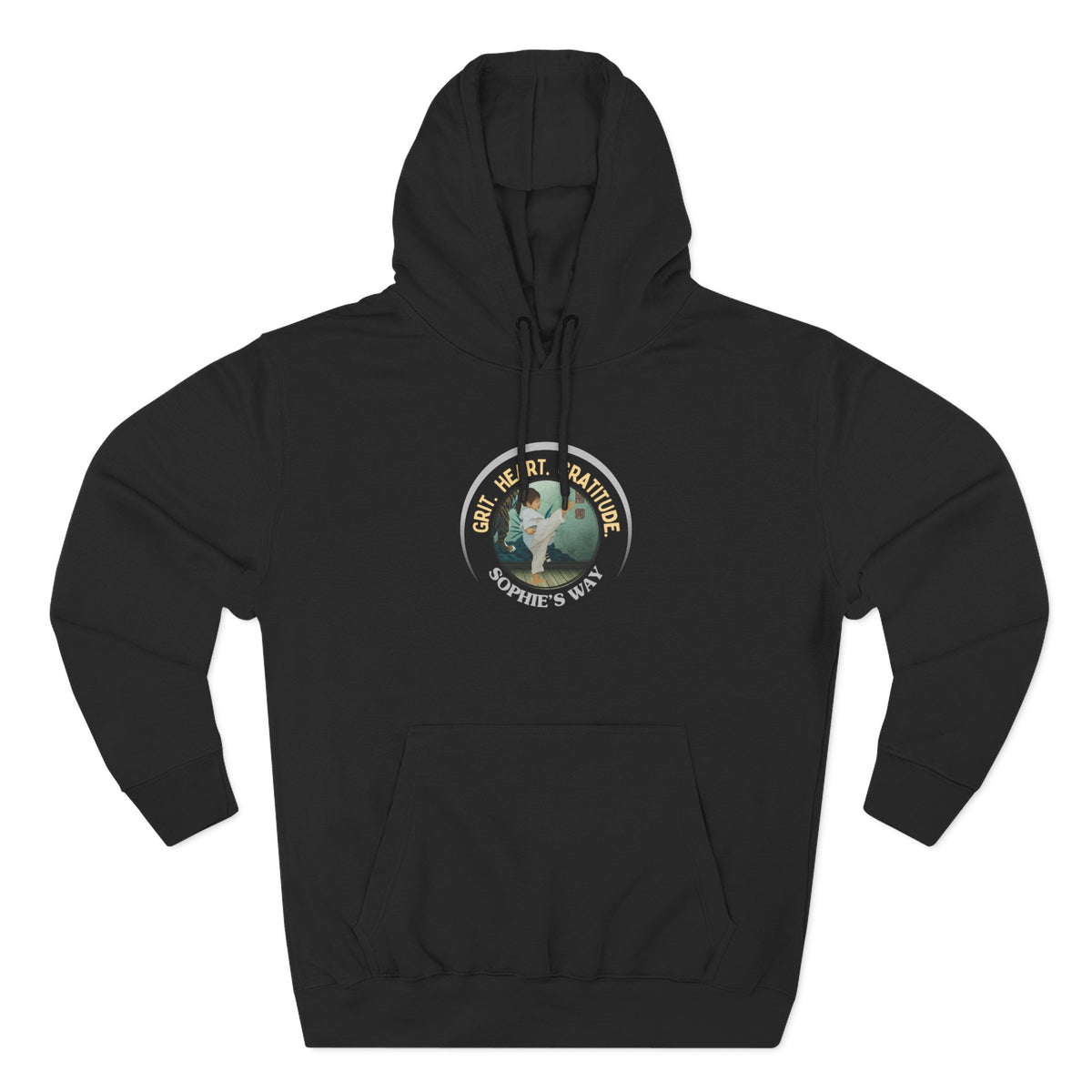 A black pullover hoodie with a circular graphic on the chest that reads 'Grit. Heart. Gratitude. Sophie's Way' around a globe design around a taekwondo tot doing a side kick. The hoodie features a drawstring hood, long sleeves, and a front kangaroo pocket.