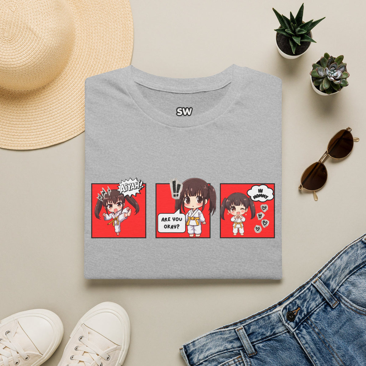 Are You Okay? unisex softstyle t-shirt in sport grey with chibi taekwondo girl three-panel comic strip graphic — "Aiyah!", "Are You Okay?", "Hi Mommy"