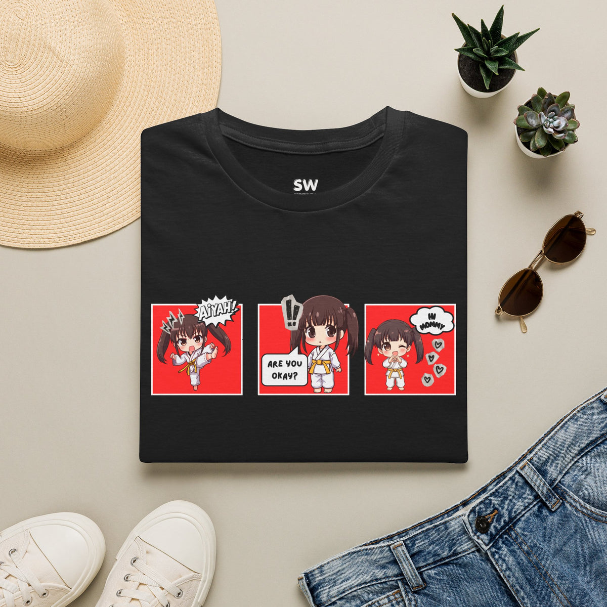 Are You Okay? unisex softstyle t-shirt in black with chibi taekwondo girl three-panel comic strip graphic — "Aiyah!", "Are You Okay?", "Hi Mommy"
