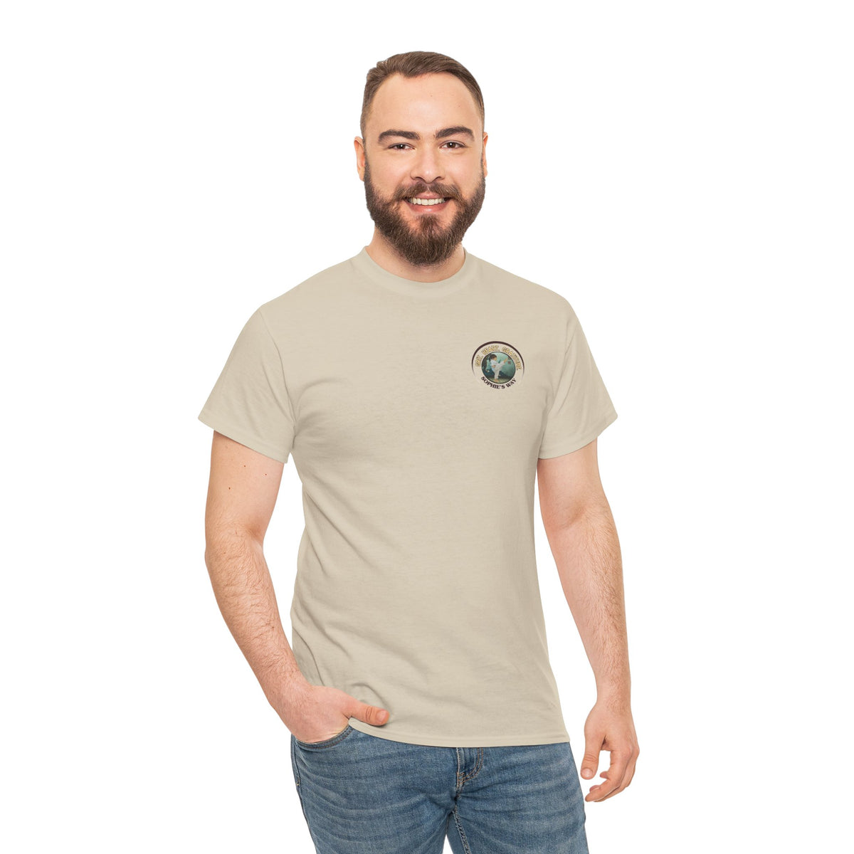 Sand colored t-shirt with a small round logo of a taekwondo girl doing a side kick and the words Grit. Heart. Gratitude. Sophie's Way.
