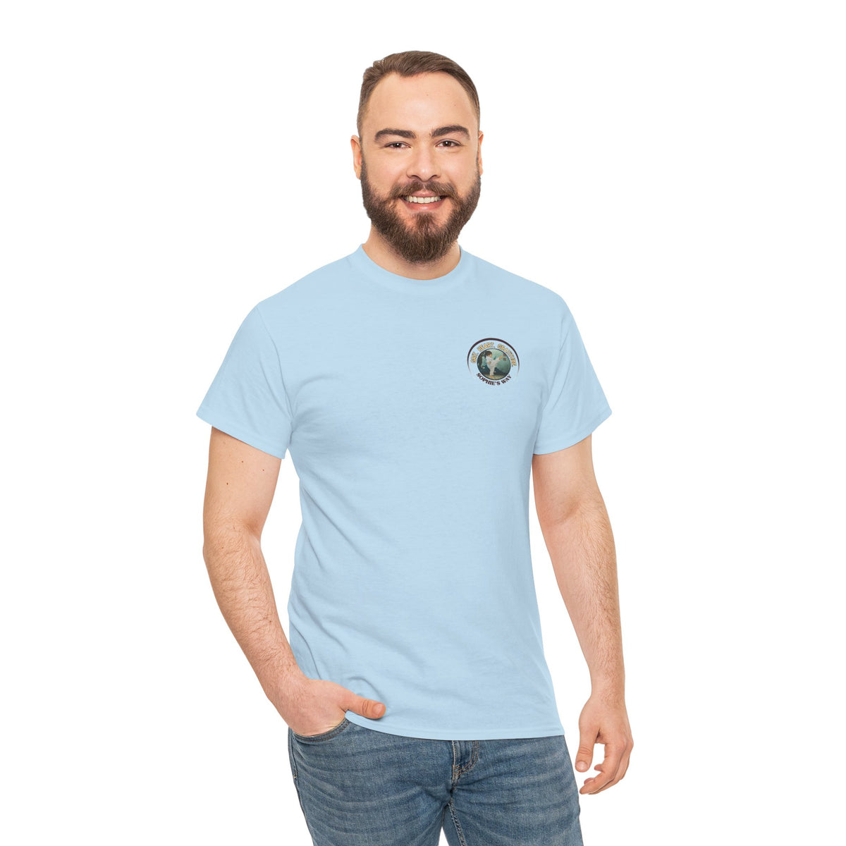 Light blue colored t-shirt with a small round logo of a taekwondo girl doing a side kick and the words Grit. Heart. Gratitude. Sophie's Way.