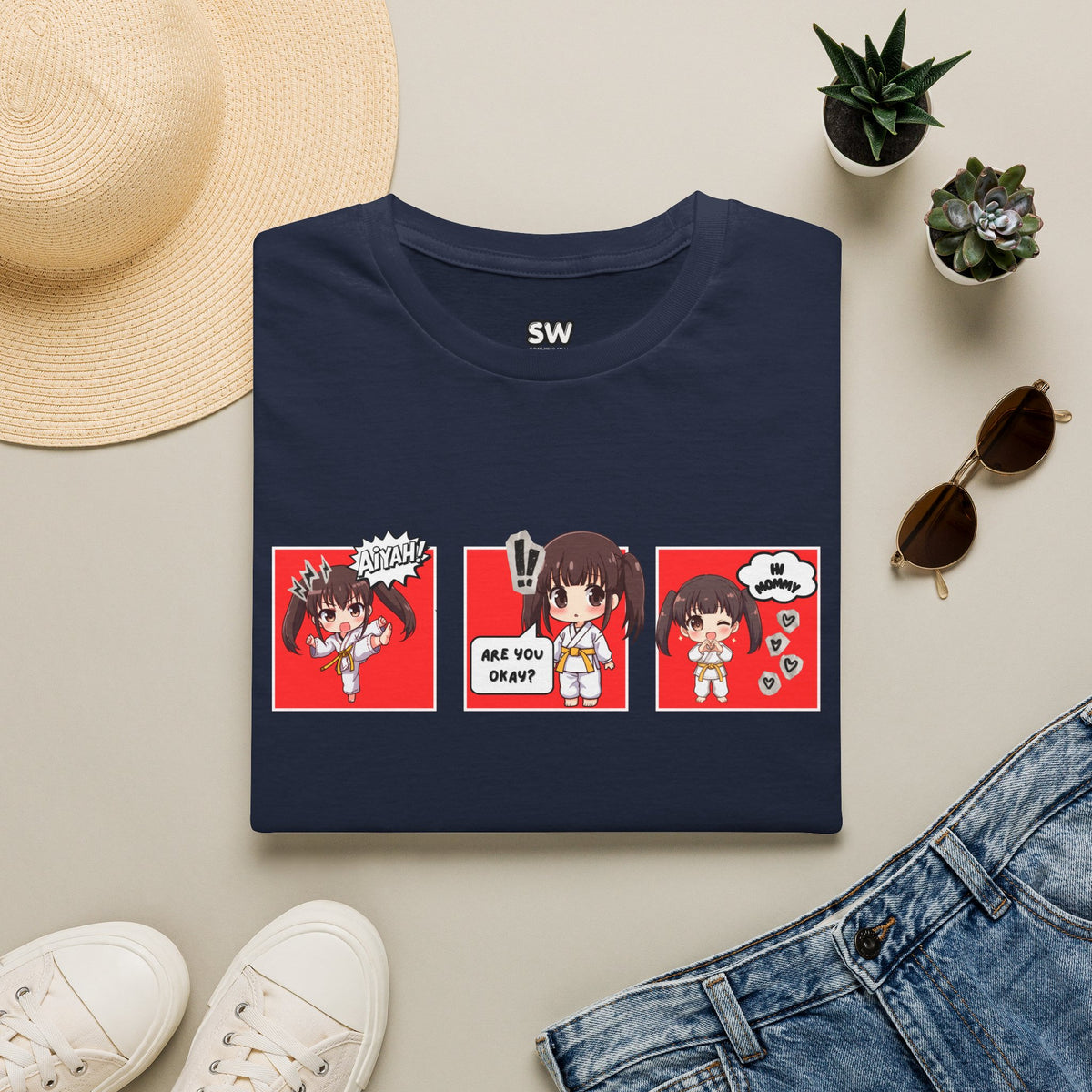 Are You Okay? unisex softstyle t-shirt in navy blue with chibi taekwondo girl three-panel comic strip graphic — "Aiyah!", "Are You Okay?", "Hi Mommy"
