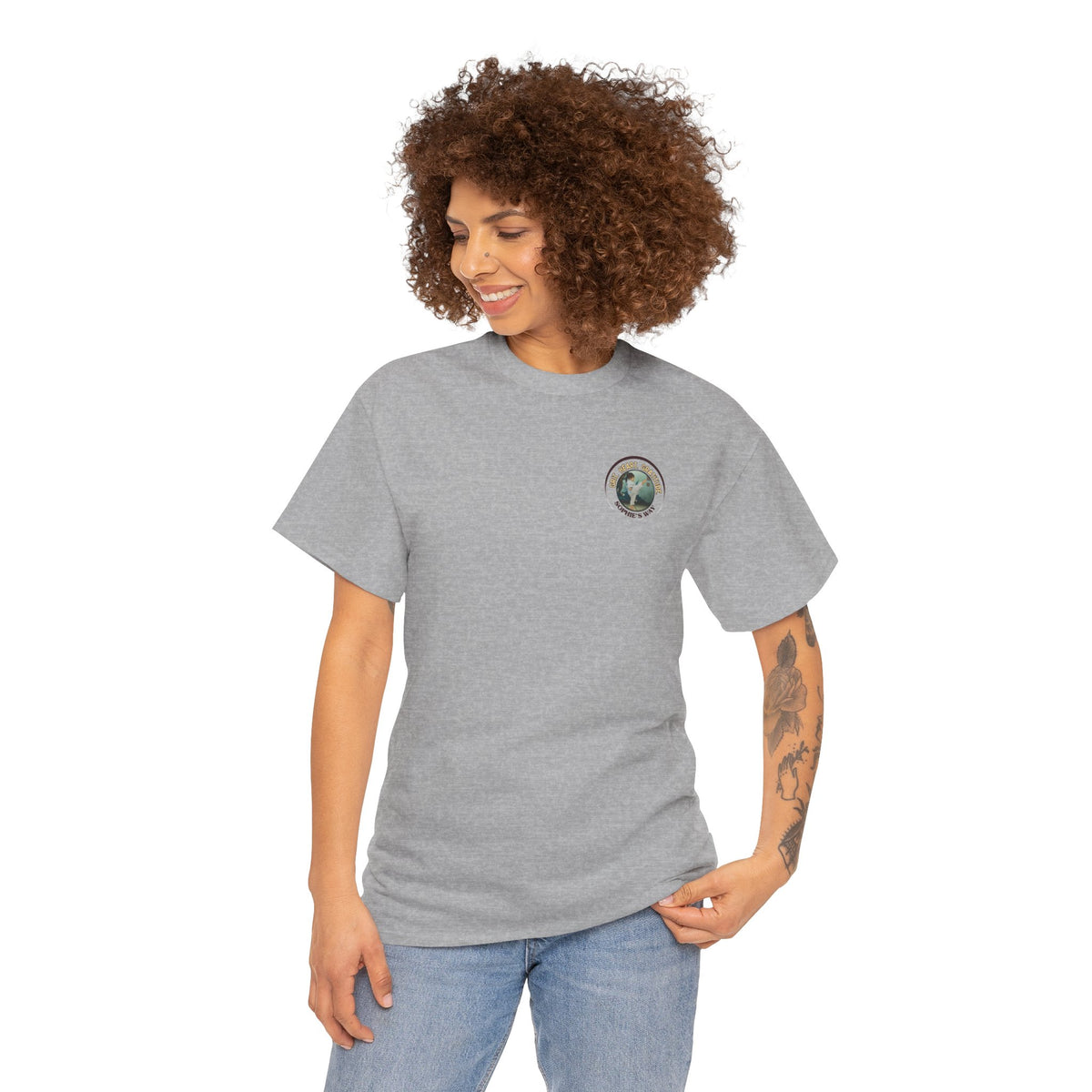 Sport grey colored t-shirt with a small round logo of a taekwondo girl doing a side kick and the words Grit. Heart. Gratitude. Sophie's Way.