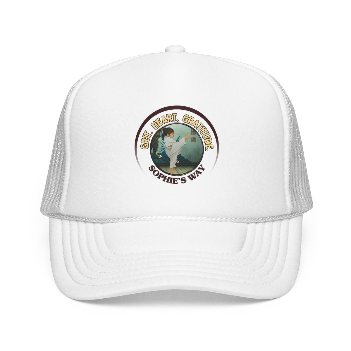 A white trucker hat with a circular graphic on the front panel. The graphic features a border with the words 'Grit. Heart. Gratitude. Sophie's Way' and a taekwondo tot doing a side kick in the center.