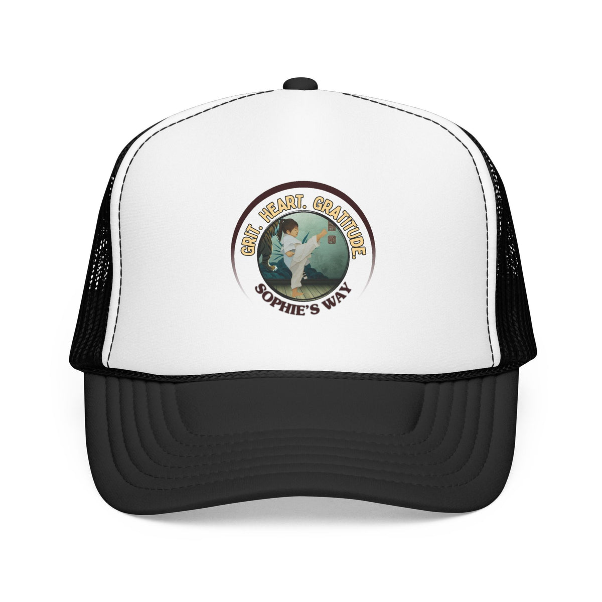 A black and white trucker hat with a circular graphic on the front panel. The graphic features a border with the words 'Grit. Heart. Gratitude. Sophie's Way' and a taekwondo tot doing a side kick in the center.